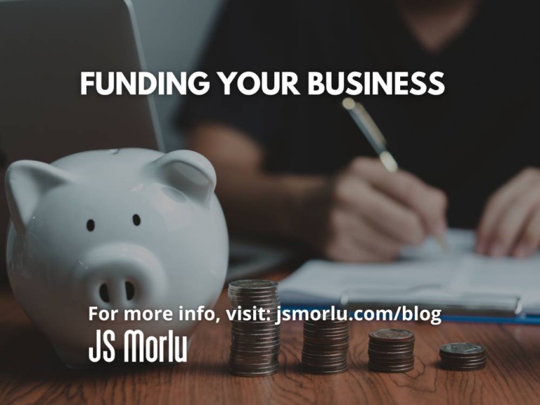 Image of a piggy bank sitting next to rows of stacked shillings - Funding Your Business
