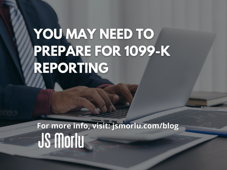 A professional man in a suit sitting at a desk, typing on a laptop keyboard - 1099-K Reporting.