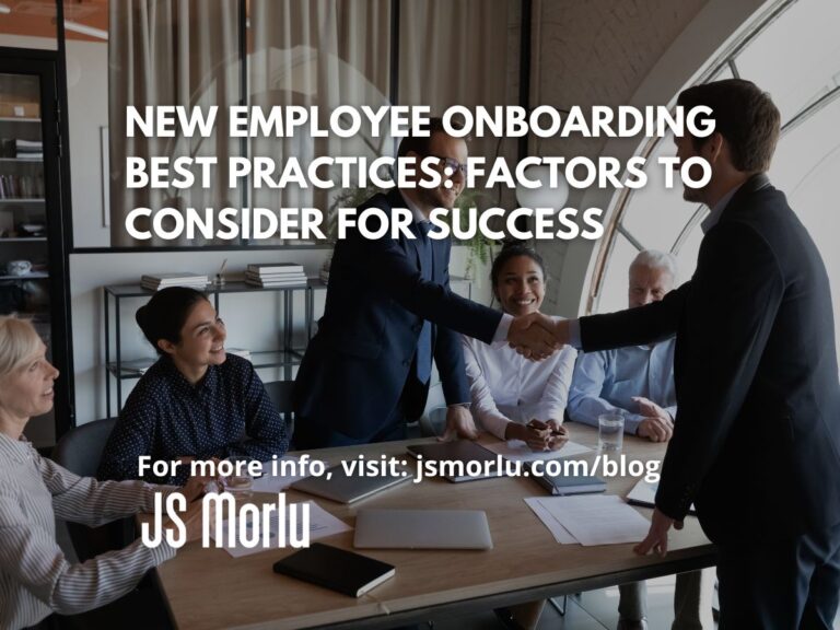 An interviewee stands and extends their hand to shake hands with the interviewer in a professional gesture of greeting - New Employee Onboarding Best Practices